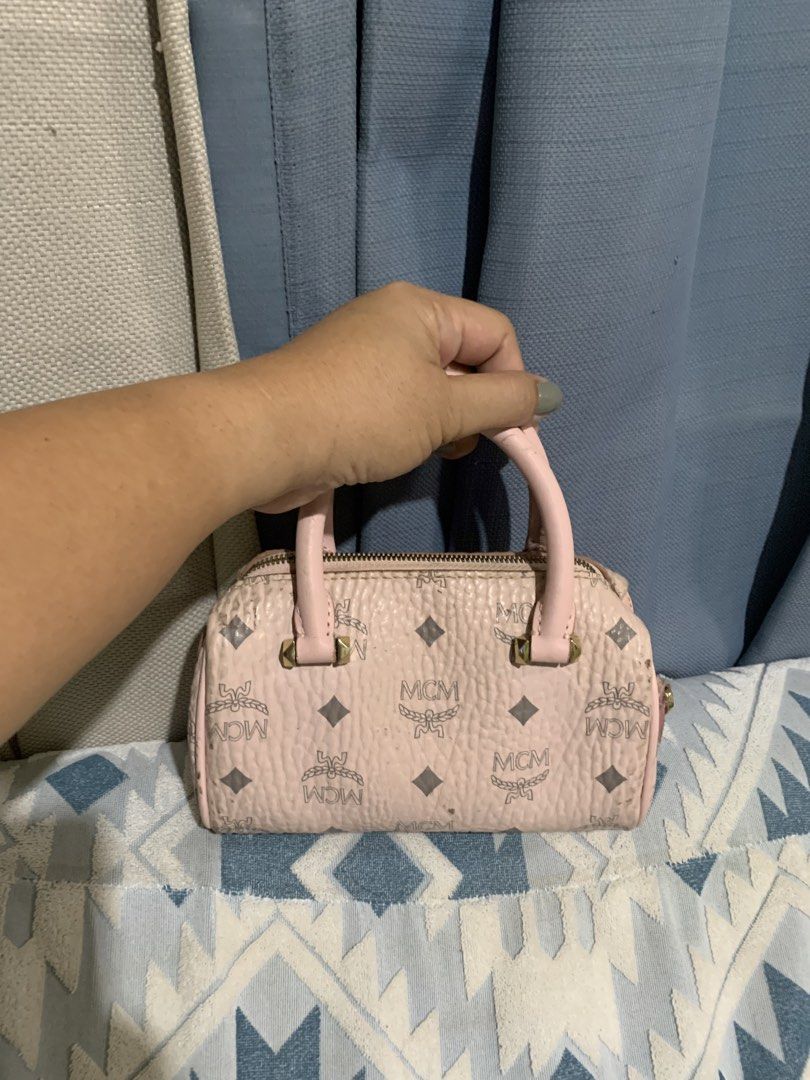MCM Pink Monogram Mini Boston Bag (Category: Luxury Bags & Wallets) located in Liloan. Submitted by jinalyns (Listing ID 1450045255, Image 2). Description: - Cute pink MCM mini Boston bag - Classic monogram print - Gold hardware details - Zipper closure - Small handles - Interior card slot - Some signs of wear on exterior and handles - Great for carrying essentials.