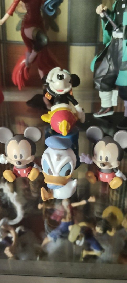 Mickey Mouse Donald Duck Figurines Set (Category: Figurines & Statues) located in San Jose. Submitted by jewels_toyshop (Listing ID 1450000534, Image 1). Description: - Adorable Disney figurine set featuring Mickey Mouse and Donald Duck. - Mickey Mouse is riding a vibrant yellow and red rocket. - Donald Duck is positioned in the center of the set. - Two additional Mickey Mouse figures are placed on the sides. - Perfect for Disney collectors or as
