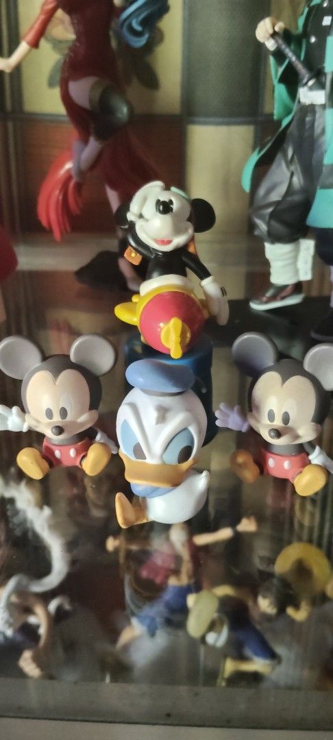 Mickey Mouse Donald Duck Figurines Set (Category: Figurines & Statues) located in San Jose. Submitted by jewels_toyshop (Listing ID 1450000534, Image 3). Description: - Adorable Disney figurine set featuring Mickey Mouse and Donald Duck. - Mickey Mouse is riding a vibrant yellow and red rocket. - Donald Duck is positioned in the center of the set. - Two additional Mickey Mouse figures are placed on the sides. - Perfect for Disney collectors or as