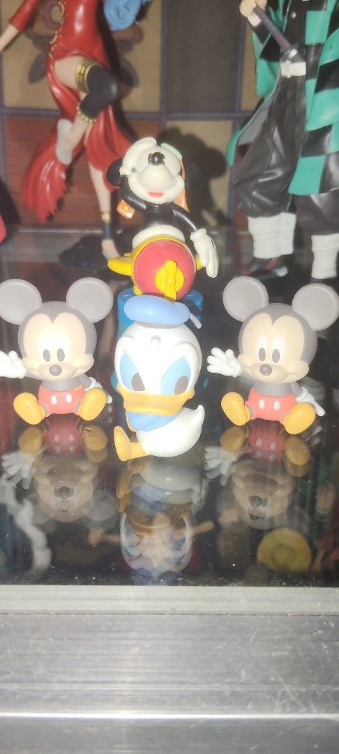 Mickey Mouse Donald Duck Figurines Set (Category: Figurines & Statues) located in San Jose. Submitted by jewels_toyshop (Listing ID 1450000534, Image 2). Description: - Adorable Disney figurine set featuring Mickey Mouse and Donald Duck. - Mickey Mouse is riding a vibrant yellow and red rocket. - Donald Duck is positioned in the center of the set. - Two additional Mickey Mouse figures are placed on the sides. - Perfect for Disney collectors or as