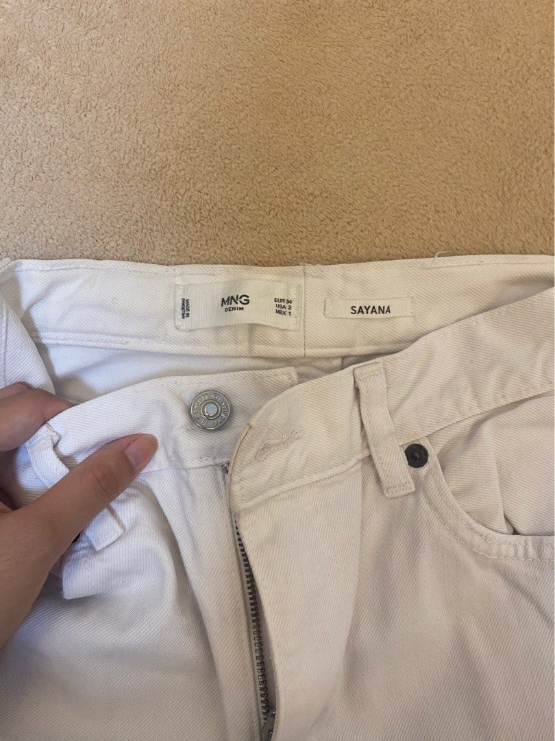MNG Denim Sayana White Jeans (Category: Jeans) located in Mandaluyong City. Submitted by weakassbitch (Listing ID 1432829205, Image 2). Description: RUSH SALE!!! - Sayana cut with raw hem - Fits xs to small - minor issue: needs washing (see 3rd picture) - see last photo for when worn .