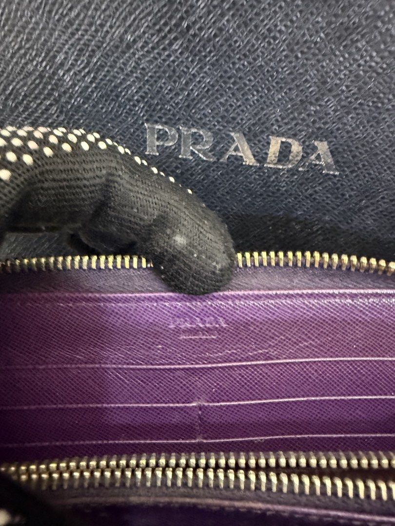 Prada Saffiano zip around leather (Category: Luxury Bags & Wallets) located in Angeles City. Submitted by bagpriceinfiniteluck (Listing ID 1449987120, Image 3). Description: Preloved 8/10 condition with fadings. Selling Super low price! 💯Prada womens zip around saffiano leather wallet in dinstinct purple hue, characterized by its cross hatch textured leather gold toned metal lettering logo and matching signature prada gift box✨ ON HAND PH🇵🇭🇵�