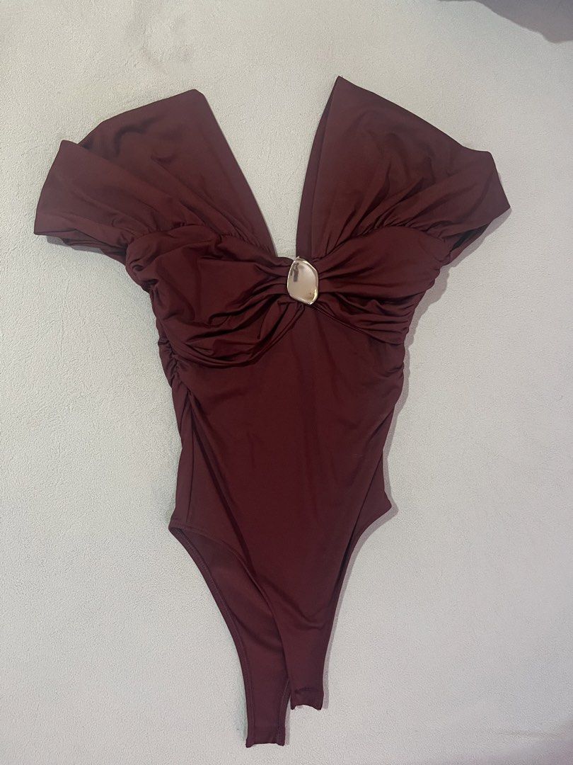 Pull & Bear Bodysuit Size S (Category: Others Tops) located in Manila. Submitted by cesca28 (Listing ID 1449965515, Image 1). Description: Maroon Pull & Bear bodysuit, size S. Features a deep V-neck with silver accent and ruched sides. .