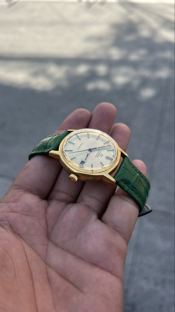Rare Vintage Omega Geneve Automatic “Pine Gold” (Category: Luxury Watches) located in Caloocan City. Submitted by _alennchan (Listing ID 1450014765, Image 2). Description: Rare Vintage Omega Geneve Automatic “Pine Gold” - Cal 1481 - Condition: 9.6/10 - No issue - Emerald green Leather Strap - Original Omega Buckles - Case size approx 37mm including crown - Ref. 166.0098 - Automatic Movement - Comes with replacement box Inclusions: Replacement box