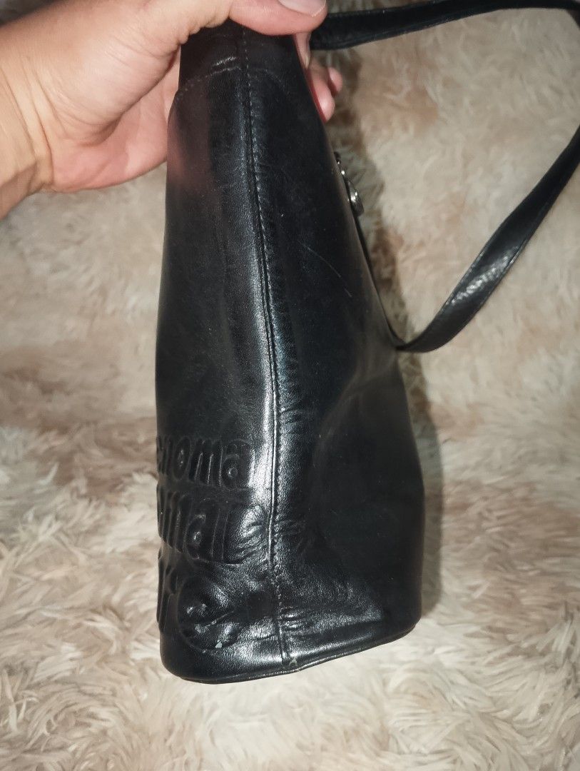 RENOMA Black Leather Shoulder Bag with Embossed Logo (Category: Shoulder Bags) located in Manila. Submitted by triple_r.shop.ph (Listing ID 1450048968, Image 3). Description: - Genuine black leather shoulder bag - Elegant embossed logo pattern on the front - Secure zipper closure located on the back - Chic silver hardware detail on the strap - Protective studs on the bottom for durability - Ideal size for everyday use and carrying essentials.