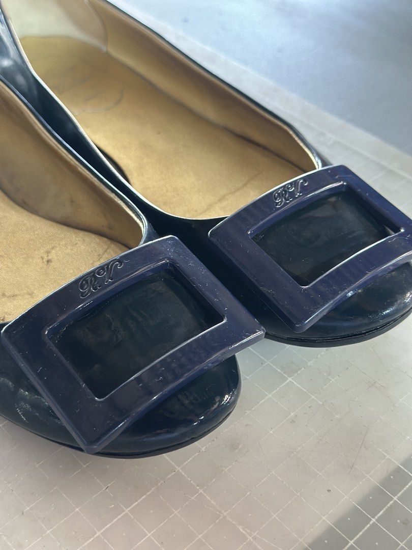 Roger Vivier Patent Leather Ballet Flats (Category: Flats & Sandals) located in Pili. Submitted by jeren2 (Listing ID 1449977427, Image 2). Description: Decluttering my shoe collection. Classic navy blue patent leather flats with the signature square buckle. A timeless style that's easy to dress up or down. • US 6 (based on tag) • Fits slightly roomy. I'm usually a US 6 and these feel a bit loose, so they may also fit a US 6.5. • Navy blue patent