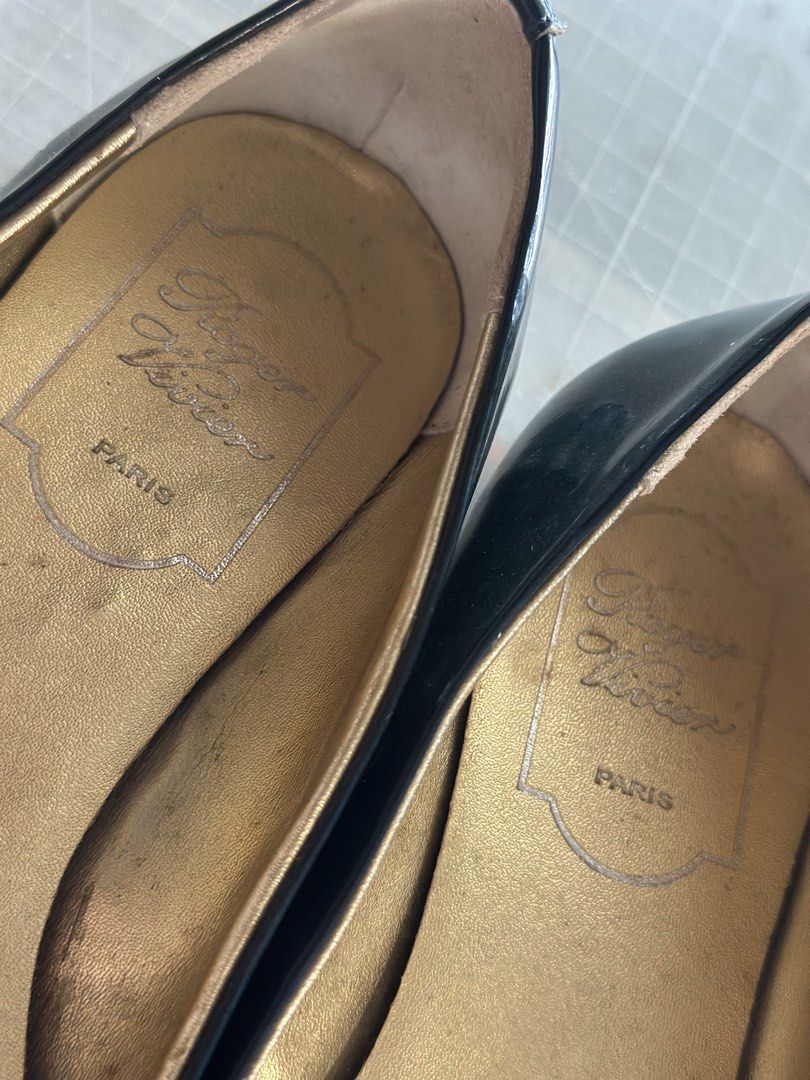 Roger Vivier Patent Leather Ballet Flats (Category: Flats & Sandals) located in Pili. Submitted by jeren2 (Listing ID 1449977427, Image 3). Description: Decluttering my shoe collection. Classic navy blue patent leather flats with the signature square buckle. A timeless style that's easy to dress up or down. • US 6 (based on tag) • Fits slightly roomy. I'm usually a US 6 and these feel a bit loose, so they may also fit a US 6.5. • Navy blue patent