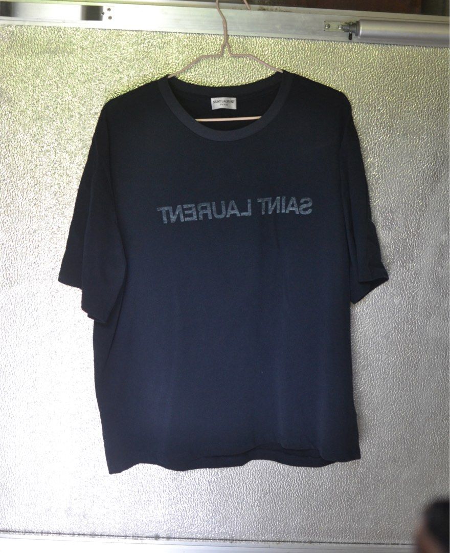 Saint Laurent Reversed Tshirt (Category: Luxury Apparel) located in Lugus. Submitted by itsluxurythings (Listing ID 1450042450, Image 1). Description: - Saint Laurent Paris T-shirt - Size: Large - Dimensions: w21.5 L27 - Color: Midnight Blue - Condition: Excellent condition look brandnew - Style: Versatile basic tee, ideal for everyday styling PM me for faster Transaction Payment via Mobile Banking or via Gcash .