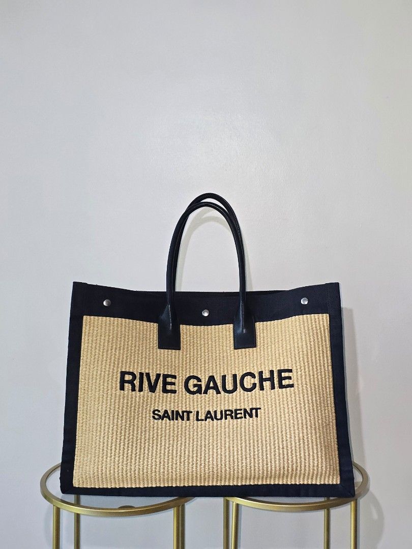 ❗️FASTBREAK❗️Saint Laurent Rive Gauche Tote Bag (Category: Luxury Bags & Wallets) located in Cebu City. Submitted by anythingunderthesun0211 (Listing ID 1450045865, Image 1). Description: - Authentic Saint Laurent Rive Gauche tote bag - Made from natural straw with black canvas trim - Features black leather handles - Chic and simple design, ideal for everyday or beach trips - Spacious interior for all your essentials with dustbag and entrupy.