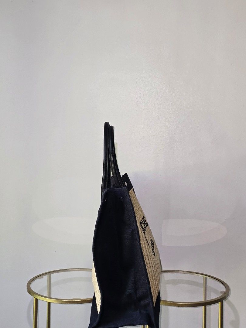 ❗️FASTBREAK❗️Saint Laurent Rive Gauche Tote Bag (Category: Luxury Bags & Wallets) located in Cebu City. Submitted by anythingunderthesun0211 (Listing ID 1450045865, Image 2). Description: - Authentic Saint Laurent Rive Gauche tote bag - Made from natural straw with black canvas trim - Features black leather handles - Chic and simple design, ideal for everyday or beach trips - Spacious interior for all your essentials with dustbag and entrupy.