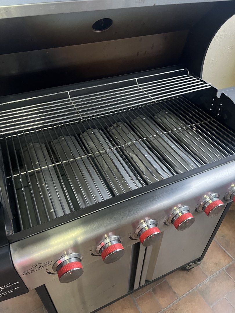 Sun Crust 6-Burner Gas BBQ Grill (Category: BBQ, Grills & Hotpots) located in Cainta. Submitted by xoxo_0924 (Listing ID 1449962912, Image 3). Description: - Powerful 6-burner gas BBQ grill - Ideal for cookouts and family gatherings - Built-in thermometer for temperature monitoring - Spacious double-door cabinet for storage - Sturdy wheels for easy mobility - Convenient side shelves for extra workspace - Durable and reliable construction.