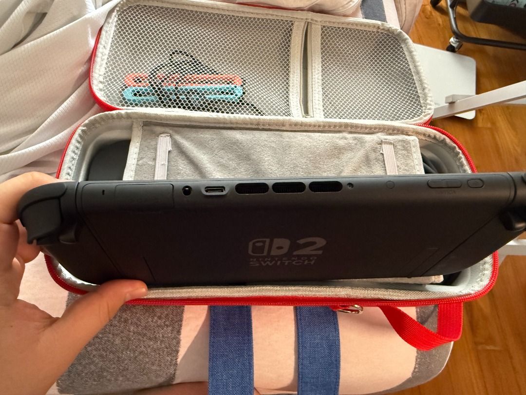 switch2 (Category: Nintendo) located in Singapore. Submitted by vastdragon.364dc7 (Listing ID 1450014831, Image 3). Description: Selling my Nintendo Switch 2 (Singapore Set). Only used 1–2 times, still in like new condition. Screen protector has been applied since day one. Everything works perfectly with no stick drift. Includes: * Nintendo Switch 2 Console * Left & Right Joy-Con * Original Dock * Original Charger * Mario Carry Case Note: * No or