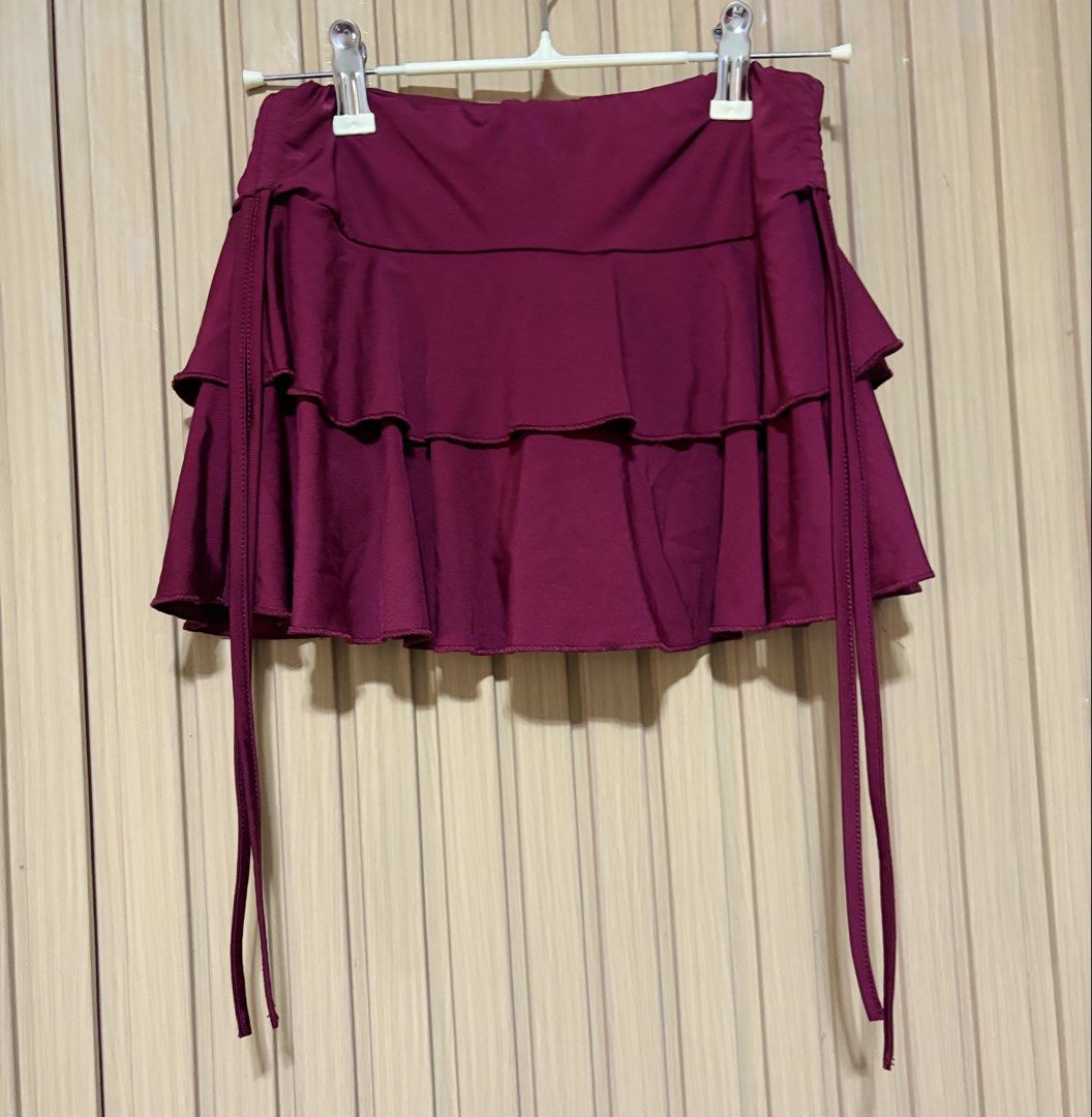 Tiered Ruffle Mini Skirt with Tie Details (Category: Skirts) located in Santa Cruz. Submitted by callilithings (Listing ID 1450071882, Image 1). Description: - Cute tiered ruffle mini skirt - Deep plum/burgundy color - Side tie details - Versatile for night out or casual wear - Easy to style with various tops - Fun and flirty design XS .