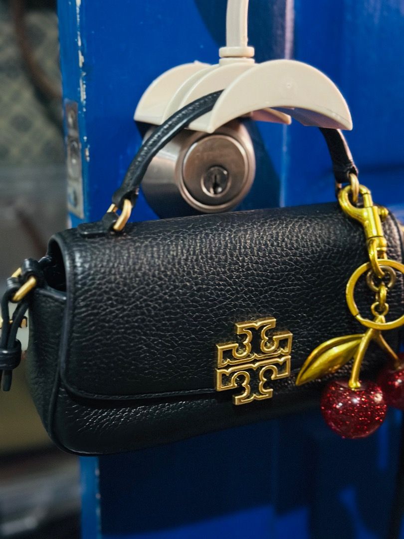 Tory Burch Britten Mini Top Handle (Category: Luxury Bags & Wallets) located in Cebu City. Submitted by isellhere123.543 (Listing ID 1449999034, Image 2). Description: - Cute black Tory Burch mini bag - Made of pebbled leather - Charm not included - Gold hardware - Features a top handle and a long strap - Ideal for carrying essentials - Perfect for nights out or elevating your style.