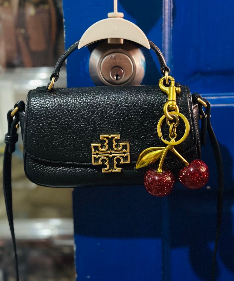 Tory Burch Britten Mini Top Handle (Category: Luxury Bags & Wallets) located in Cebu City. Submitted by isellhere123.543 (Listing ID 1449999034, Image 1). Description: - Cute black Tory Burch mini bag - Made of pebbled leather - Charm not included - Gold hardware - Features a top handle and a long strap - Ideal for carrying essentials - Perfect for nights out or elevating your style.