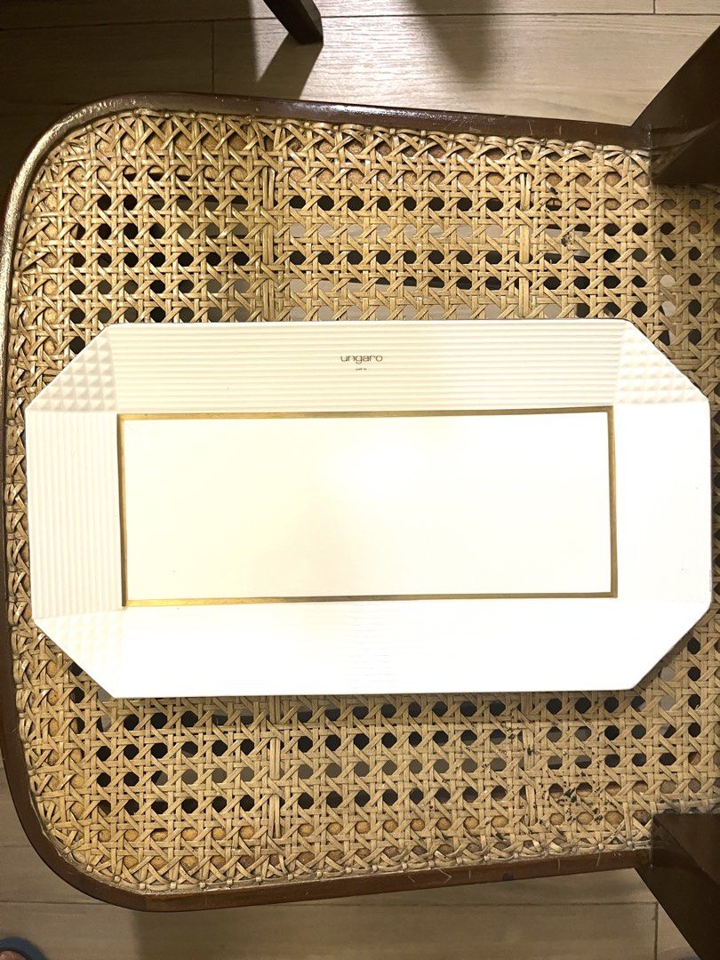 Ungaro Paris Maebata Serving Platter (Category: Dinnerware & Cutlery) located in Pasig City. Submitted by tylernchloe (Listing ID 1450050416, Image 1). Description: - Elegant white serving platter with a sophisticated gold trim. - Generous size: approximately 14 inches long and 7 3/4 inches wide. - Ideal for serving appetizers, desserts, or as a decorative piece. .