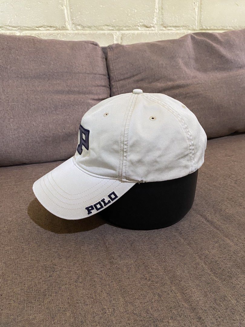 Vintage Polo Ralph Lauren Cap (Category: Caps & Hats) located in Cebu City. Submitted by patspickph (Listing ID 1450000469, Image 3). Description: This is a vintage Polo Ralph Lauren baseball cap featuring a distinctive chenille "P" logo. *Style: Known as a vintage 90s "Big P" or university-style cap. *Design Details: Features a prominent chenille "P" on the front and "POLO" text embroidered on the side of the brim. The wear of this cap is truly 
