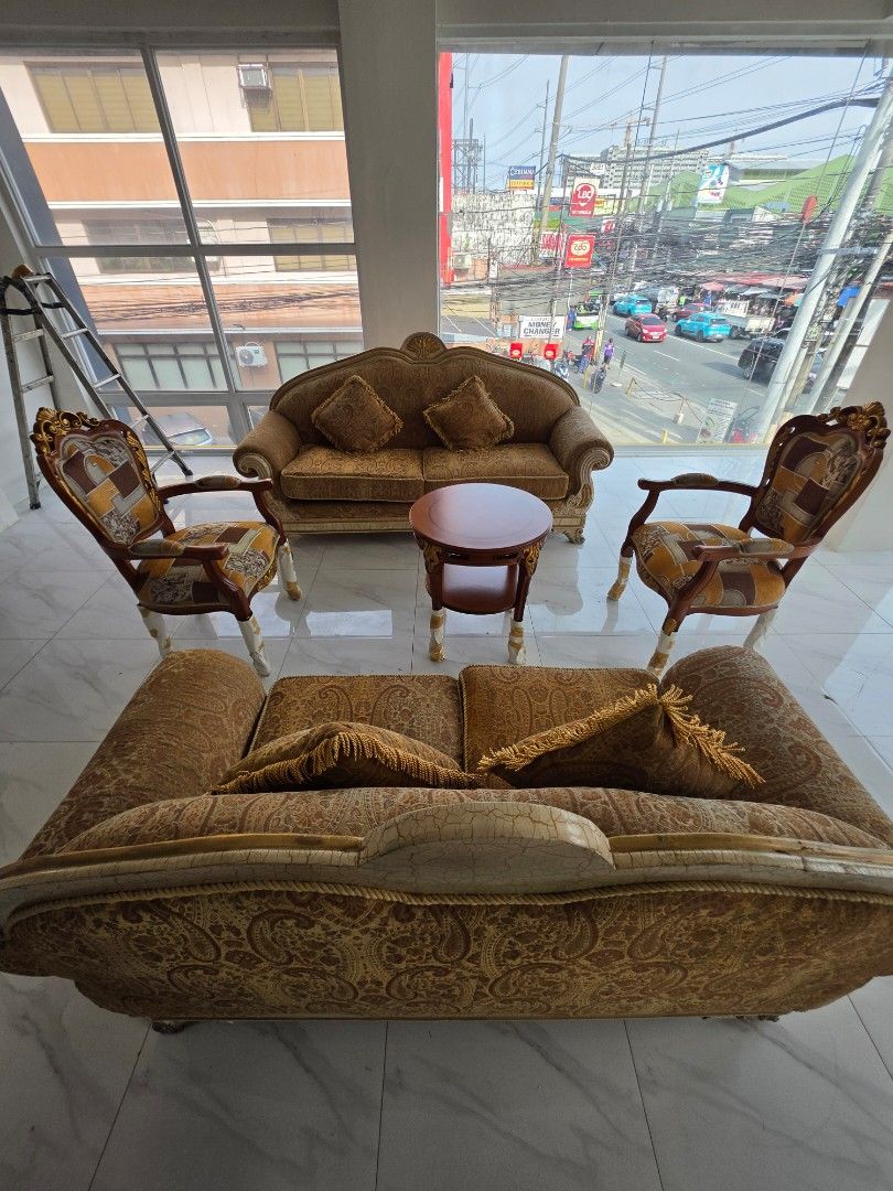 Vintage Style Sofa Set with Chairs and Coffee Table (Category: Sofas) located in Las Pinas. Submitted by nbdg06 (Listing ID 1450028421, Image 1). Description: - Vintage-style sofa set - Includes: 1x 3-seater sofa, 1x 2-seater sofa,2x armchairs, 1 x coffee table - Comes with a small round coffee table - Upholstered in patterned fabric - Features ornate wooden trim - Cushions are included - Ideal for living room or lounge area - Needs a new home!.