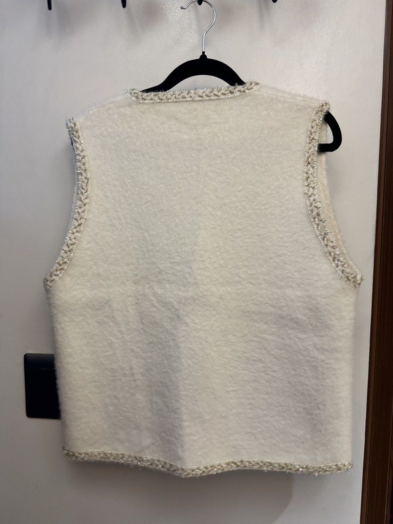 White Boucle Vest with Embellished Trim (Category: Others Tops) located in Makati City. Submitted by reenita (Listing ID 1450083616, Image 2). Description: - Chic white boucle vest - Flattering V-neckline - Easy button-up front - Two chest pockets and two hip pockets - Edges and pockets trimmed with braided, sparkly thread - Clear, faceted button details - Ideal for stylish layering over various tops.