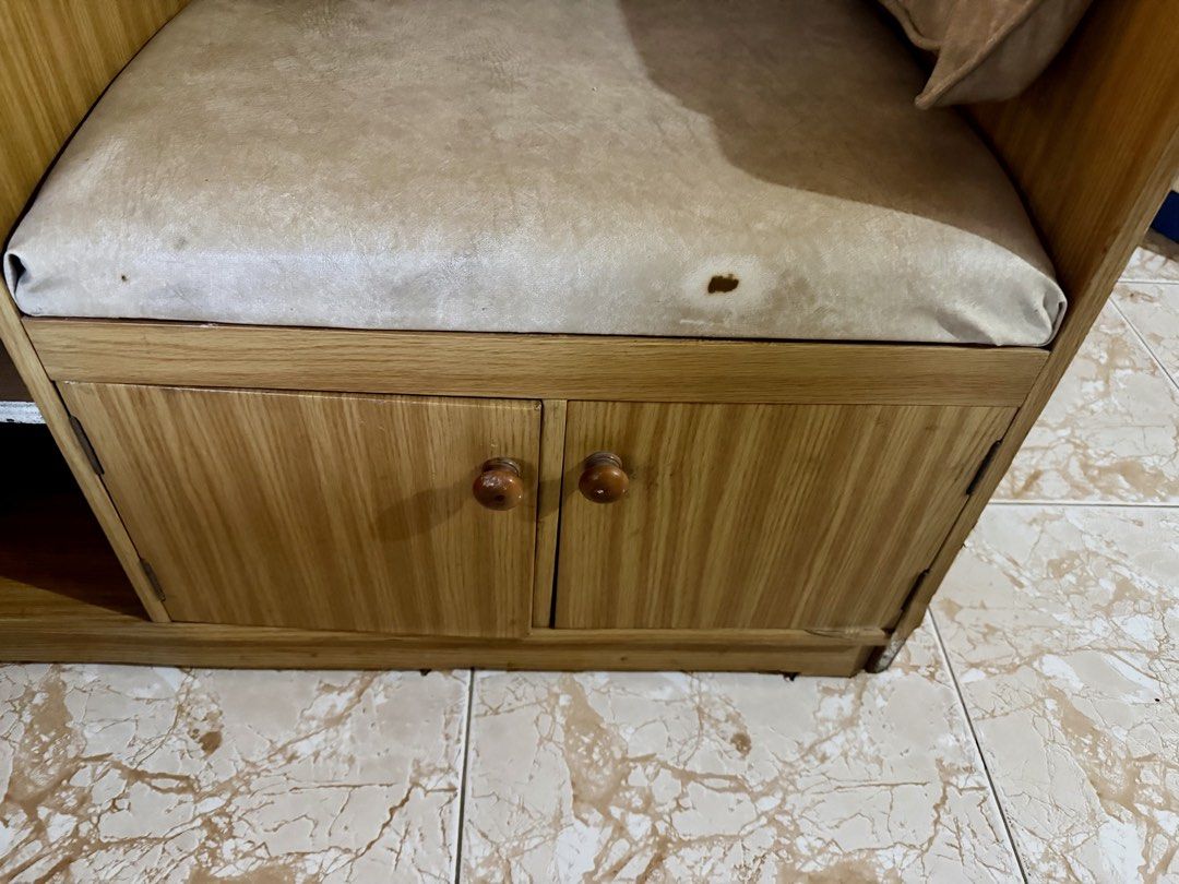 Wooden Storage Bench with Side Table and Seat (Category: Chairs) located in Quezon City. Submitted by eleventwelveph (Listing ID 1449977480, Image 3). Description: - Versatile wooden storage bench with integrated side table. - Ample storage: drawer and cabinet space below the seat. - Comfortable light beige cushioned seat. - Note: Small tear on the cushion. - Side table includes its own drawer and cabinet door. - Ideal for entryway organization o
