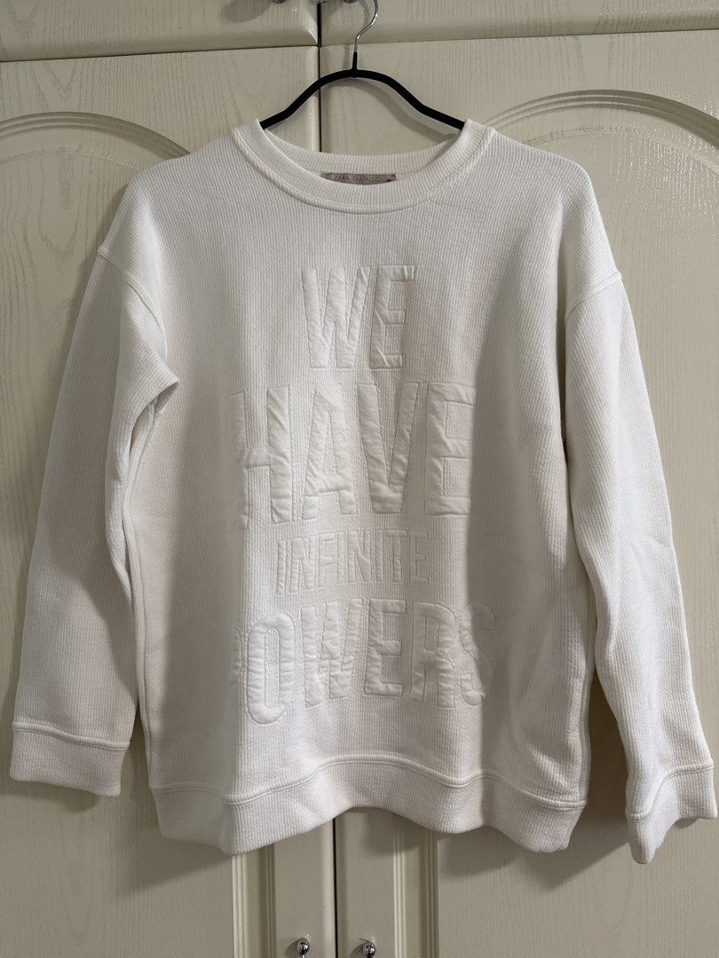Zara White Crewneck Sweatshirt with Text (Category: Coats, Jackets and Outerwear) located in Makati City. Submitted by dpfran (Listing ID 1450006501, Image 1). Description: - White crewneck sweatshirt - Features embossed text: "WE HAVE INFINITE DREAMS" - Textured fabric for a unique feel - Long sleeves with ribbed cuffs - Ribbed hem for a comfortable fit - Simple and versatile style - Ideal for everyday casual wear.