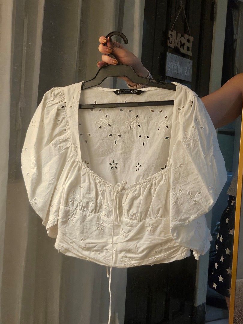 ZARA White Eyelet Top (Category: Blouses) located in Mandaluyong City. Submitted by efril.pecson (Listing ID 1450086617, Image 1). Description: - White cropped top from ZARA - Features all-over eyelet embroidery - Drawstring detail at the neckline - Smocked hem for a comfortable fit - Short sleeves - Made in India - Size S.