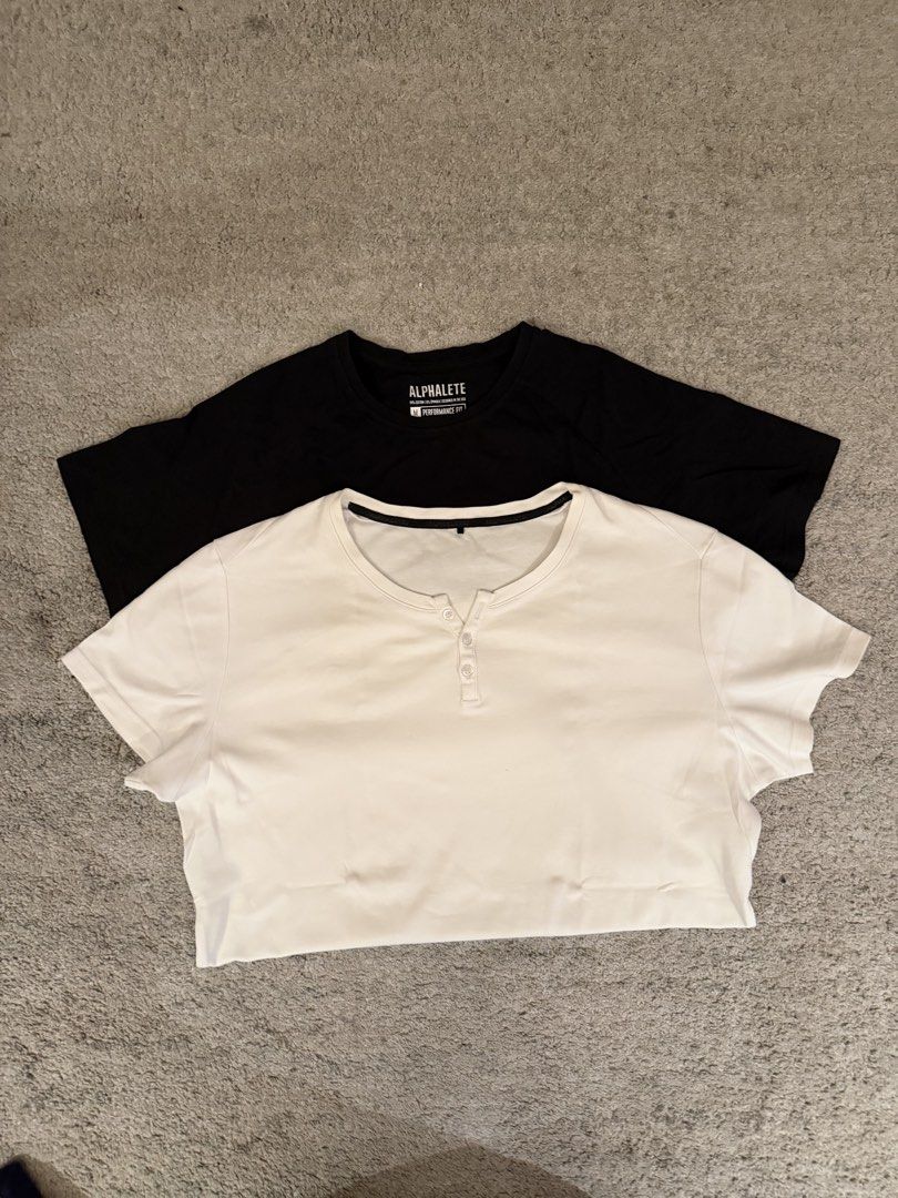 Alphalete T-Shirts (Black & White) (Category: Tshirts & Polo Shirts ) located in Manila. Submitted by decluttersiris (Listing ID 1450238661, Image 3). Description: - Two Alphalete T-shirts, Size Medium - Black T-shirt: Features 'Stafford, Texas USA' and 'Designed in the USA' print - White T-shirt: Henley style with button details - Versatile: Great for gym workouts or casual everyday wear.