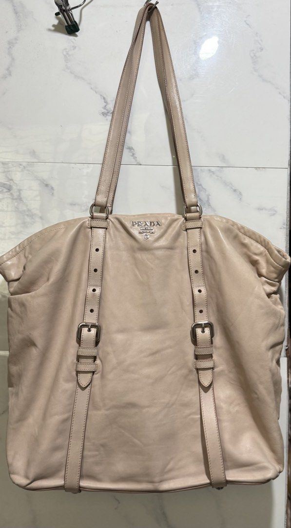 Authentic Prada Nappa leather New Look tote (Category: Luxury Bags & Wallets) located in Manila. Submitted by deoksun (Listing ID 1450248050, Image 3). Description: Authentic Negotiable nappa leather body clochette adjustable flat leather straps interior zip and slip pockets peach Condition: GOOD. This previously owned and used item is in good condition with minimal signs of use. Please refer to the photos on this product page for a detailed view