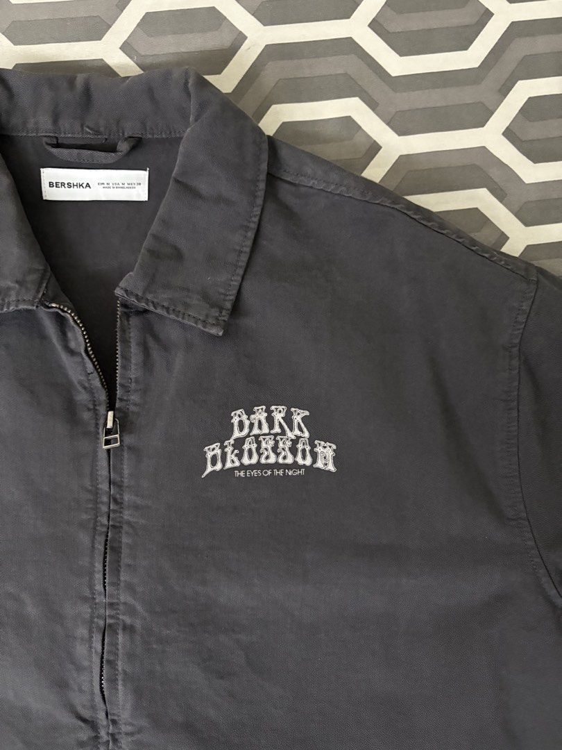 Bershka Dark Blossom Zip Up Jacket (Category: Tshirts & Polo Shirts ) located in Manila. Submitted by markrobles54253 (Listing ID 1450212969, Image 2). Description: - used once - m on tag but fits large - Bershka grey zip-up jacket - Features 'Dark Blossom The Eyes of the Night' chest graphic - Short sleeves - Collared design - Perfect for layering or as a light jacket - Please check photos for condition details.
