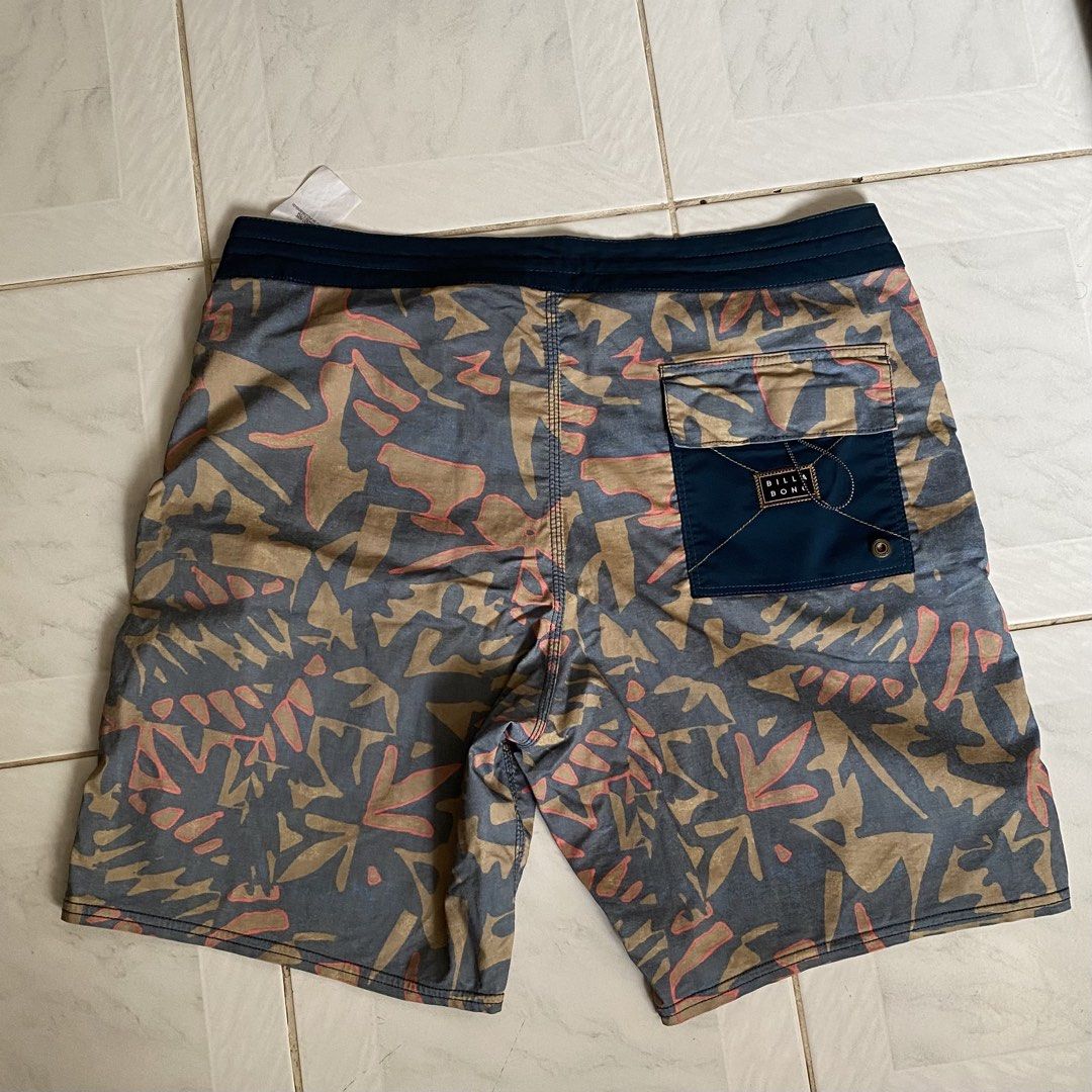Billabong Board Shorts - Men's Size M (Category: Swim Trunks & Board Shorts) located in Dumaguete. Submitted by _ninz_ (Listing ID 1450151829, Image 2). Description: -Size 30-34 Mens - Brand: Billabong - Style: Board Shorts - Design: Cool abstract leaf pattern in blue, tan, and pink - Features: Elastic waistband with drawstring, back pocket with velcro closure - Ideal for: Beach, pool, and outdoor adventures.