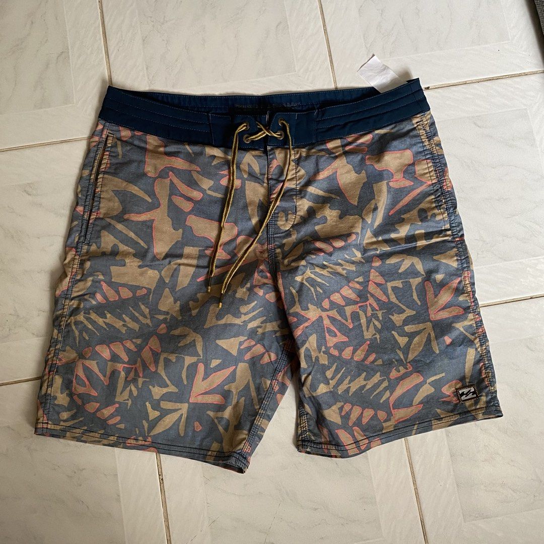 Billabong Board Shorts - Men's Size M (Category: Swim Trunks & Board Shorts) located in Dumaguete. Submitted by _ninz_ (Listing ID 1450151829, Image 1). Description: -Size 30-34 Mens - Brand: Billabong - Style: Board Shorts - Design: Cool abstract leaf pattern in blue, tan, and pink - Features: Elastic waistband with drawstring, back pocket with velcro closure - Ideal for: Beach, pool, and outdoor adventures.