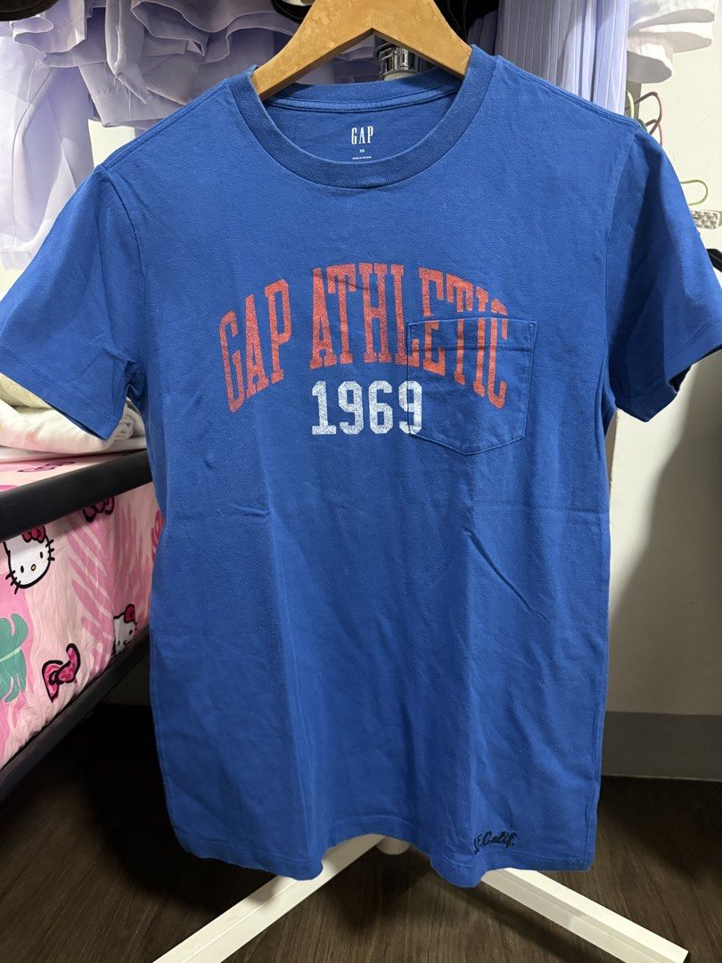 Blue GAP Athletic 1969 T-shirt (Category: Tshirts & Polo Shirts ) located in Tarlac. Submitted by jemserrano (Listing ID 1450309846, Image 1). Description: - Brand: GAP - Color: Blue - Graphic Print: 'GAP Athletic 1969' on front - Features: Chest pocket - Accent Graphic: 'S. Calif.' near hem - Style: Casual wear.