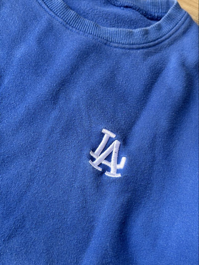 Blue LA Crewneck Sweatshirt (Category: Coats, Jackets and Outerwear) located in Quezon City. Submitted by prelovednd21 (Listing ID 1450227933, Image 3). Description: Small - Semi Large - Embroidered logo on chest - Long sleeves with ribbed cuffs and hem - Comfortable and casual design - Versatile for pairing with jeans or shorts .