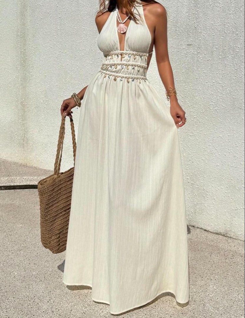 Boho Halter Neck Maxi Dress with Shell Embellishments (Category: Dresses) located in Manila. Submitted by graciouslygraceee (Listing ID 1450242307, Image 1). Description: - Cream/off-white halter neck maxi dress - Deep V-neckline - Smocked waist with shell and bead embellishments - Open back with tie closure - Flowy skirt - Estimated size: XXS - Ideal for beach or vacation wear.