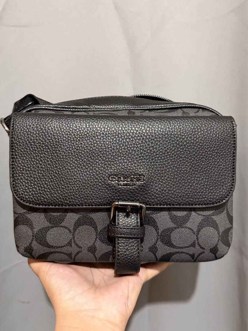 Coach Monogram Crossbody Bag Black Grey (Category: Luxury Bags & Wallets) located in Cebu City. Submitted by ivanprince23. (Listing ID 1450270665, Image 1). Description: - Authentic Coach crossbody bag - Signature monogram print in black and grey - Textured leather flap with buckle detail - Secure zipper closure on top - Branded leather tag inside - Ample interior space for essentials - Adjustable strap for comfortable wear.