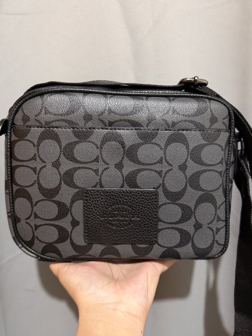 Coach Monogram Crossbody Bag Black Grey (Category: Luxury Bags & Wallets) located in Cebu City. Submitted by ivanprince23. (Listing ID 1450270665, Image 2). Description: - Authentic Coach crossbody bag - Signature monogram print in black and grey - Textured leather flap with buckle detail - Secure zipper closure on top - Branded leather tag inside - Ample interior space for essentials - Adjustable strap for comfortable wear.