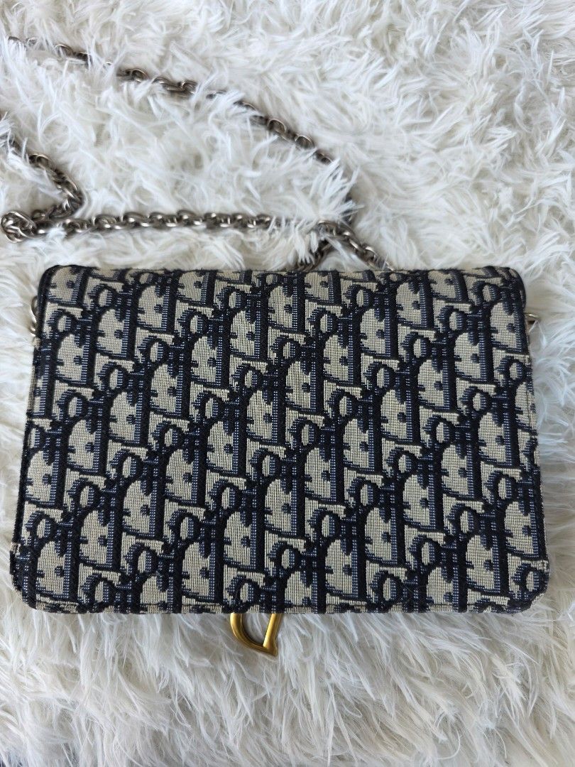 Dior Saddle Wallet on Chain Oblique Canvas (Category: Luxury Bags & Wallets) located in Lemery. Submitted by venus23 (Listing ID 1450209355, Image 2). Description: - Dior Saddle Wallet on Chain - Iconic Dior Oblique canvas - Elegant gold hardware with D-ring detail - Secure zipper closure - Dior underzip - Detachable chain strap for shoulder or crossbody styling - Compact and perfect for carrying your essentials -Replacement Sling.