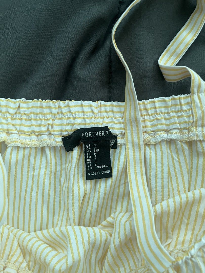 FOREVER21 Yellow Striped Ruffle Cami Top Size S (Category: Sleeveless) located in Cavite. Submitted by Djbstuff (Listing ID 1450205269, Image 2). Description: - Cute yellow and white striped cami top - Brand: Forever 21 - Features a ruffled overlay - Adjustable spaghetti straps - Elasticated neckline for comfort - Ideal for casual wear or layering.