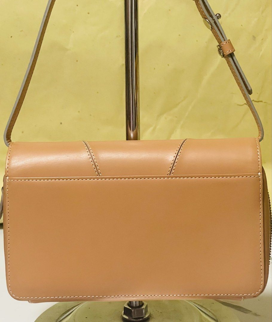 Givenchy 4G Leather Shoulder bag/Clutch Tan (Category: Luxury Bags & Wallets) located in Manila. Submitted by ermenchita71969 (Listing ID 1450295739, Image 2). Description: - Authentic Givenchy tan leather wallet - Features embossed Givenchy logo on the front - Ample card slots for organization - Zippered compartment for coins or small essentials - Adjustable strap for convenience - Versatile for everyday use or a night out - With Certificate of 