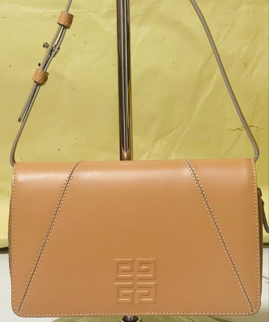 Givenchy 4G Leather Shoulder bag/Clutch Tan (Category: Luxury Bags & Wallets) located in Manila. Submitted by ermenchita71969 (Listing ID 1450295739, Image 1). Description: - Authentic Givenchy tan leather wallet - Features embossed Givenchy logo on the front - Ample card slots for organization - Zippered compartment for coins or small essentials - Adjustable strap for convenience - Versatile for everyday use or a night out - With Certificate of 