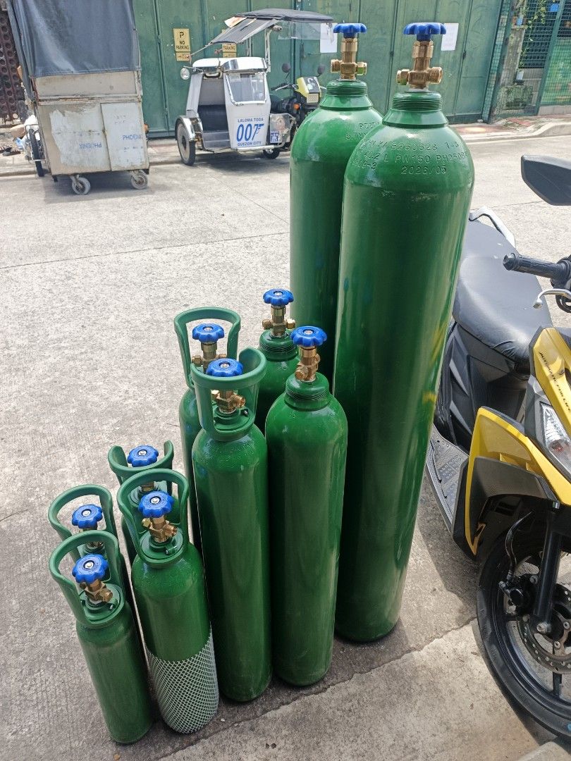 Green Oxygen Tanks Assorted Sizes (Category: Medical Supplies & Tools) located in Quezon City. Submitted by baborjerry58098 (Listing ID 1450212047, Image 2). Description: - Set of green oxygen tanks available in various sizes. - Features blue valves and brass fittings. - Suitable for both medical and industrial applications. - Ready for immediate pickup..