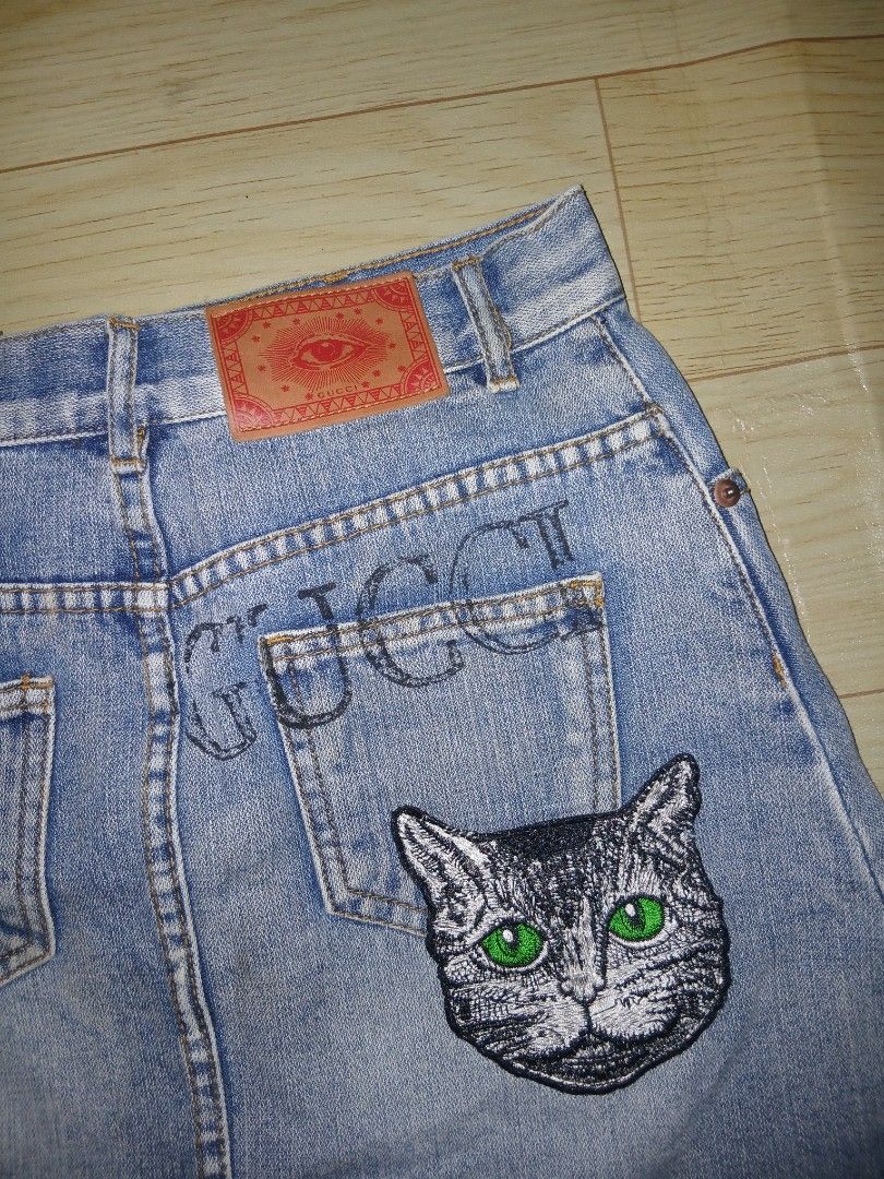 Gucci Denim Skirt with Cat Patch (Category: Luxury Apparel) located in General Santos City (Dadiangas). Submitted by afsph1996 (Listing ID 1450247306, Image 3). Description: - Light wash denim skirt -Size medium -Waistline 27-28 -Length 16 - Features a cute embroidered cat patch on the back pocket - Gucci logo also visible on the back - Button and zip closure at the front - Two front pockets and two back pockets - Ideal for a casual look.