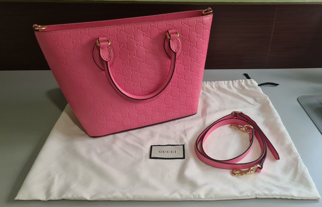 Gucci Pink Leather Embossed Top Handle Bag (Category: Luxury Bags & Wallets) located in Manila. Submitted by lc_declut (Listing ID 1450150956, Image 1). Description: - Authentic Gucci bag - Lovely pink shade - Signature GG embossed leather - Detachable shoulder strap - Gold hardware details - Dust bag included - Versatile for everyday or special occasions.