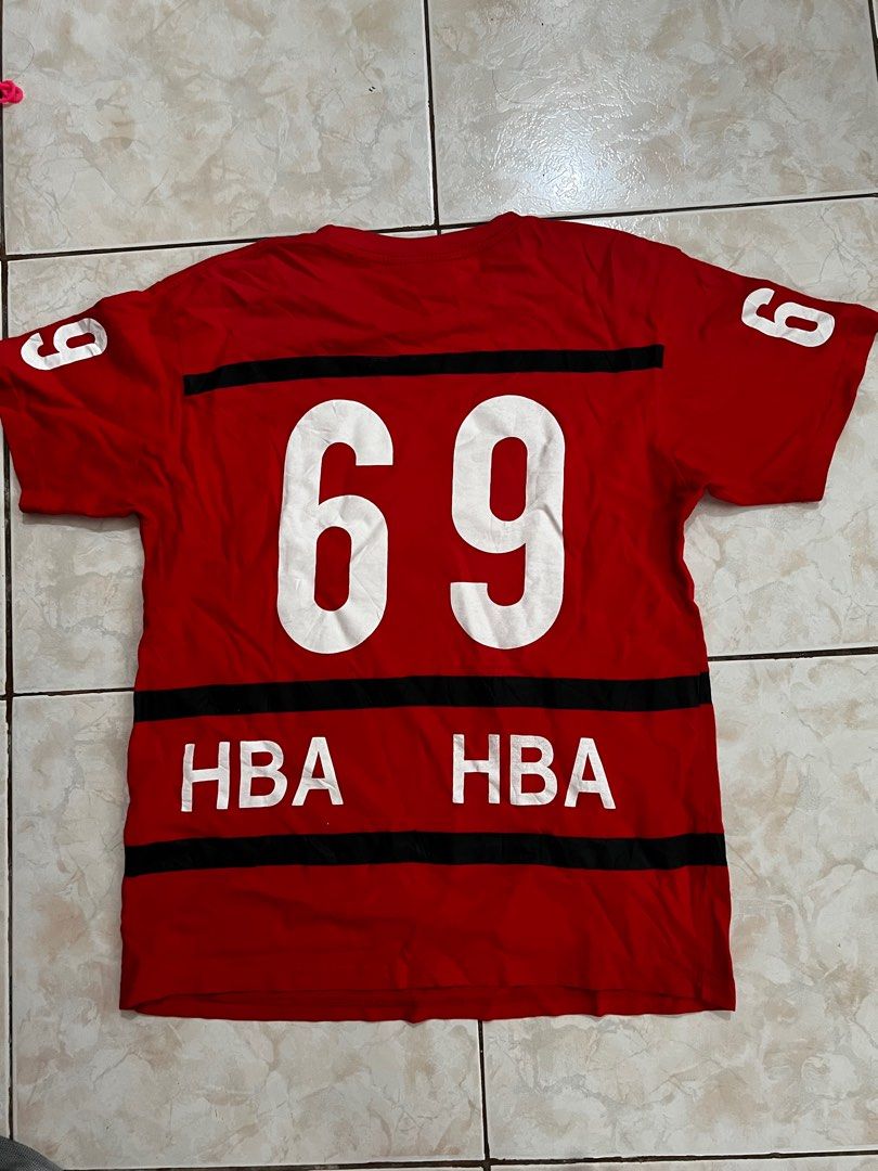 HBA Red Graphic T-Shirt Size M (Category: Tshirts & Polo Shirts ) located in Quezon City. Submitted by dayothrift_ph (Listing ID 1450198337, Image 3). Description: - Red HBA t-shirt with eye-catching graphic print. - Features the iconic 'HBA' logo prominently on the front. - Bold '69' graphic on the back for added style. - Subtle '9' detail on both sleeves. - Estimated size Medium (M). - Ideal for everyday casual wear..