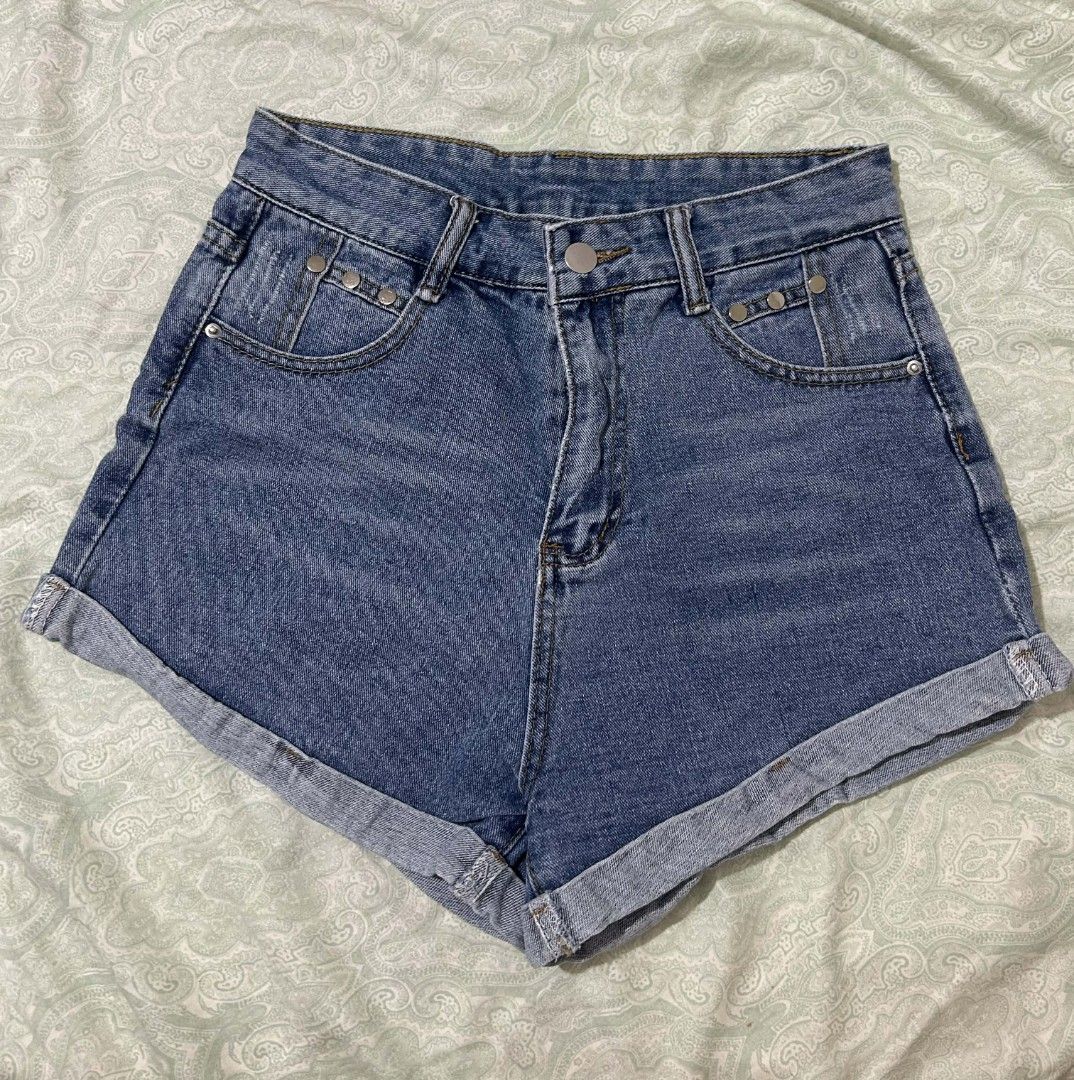 High Waisted Ripped Denim Shorts (Category: Shorts) located in Cebu City. Submitted by ibyang_blgn (Listing ID 1450176904, Image 1). Description: - High-waisted blue denim shorts - Cuffed hems - Distressed details on back pockets - Button and zip front closure - Comfortable fit for casual wear.