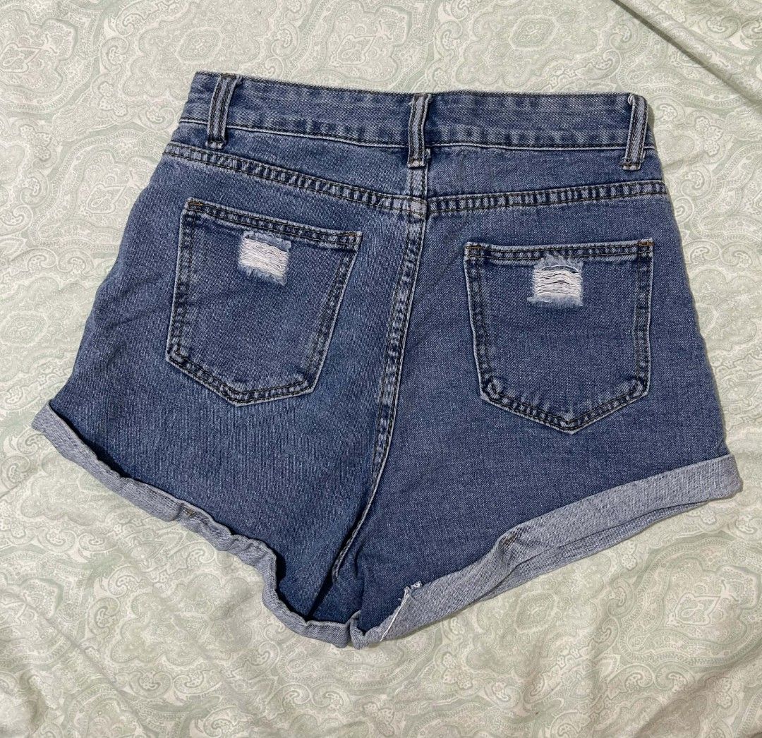 High Waisted Ripped Denim Shorts (Category: Shorts) located in Cebu City. Submitted by ibyang_blgn (Listing ID 1450176904, Image 2). Description: - High-waisted blue denim shorts - Cuffed hems - Distressed details on back pockets - Button and zip front closure - Comfortable fit for casual wear.