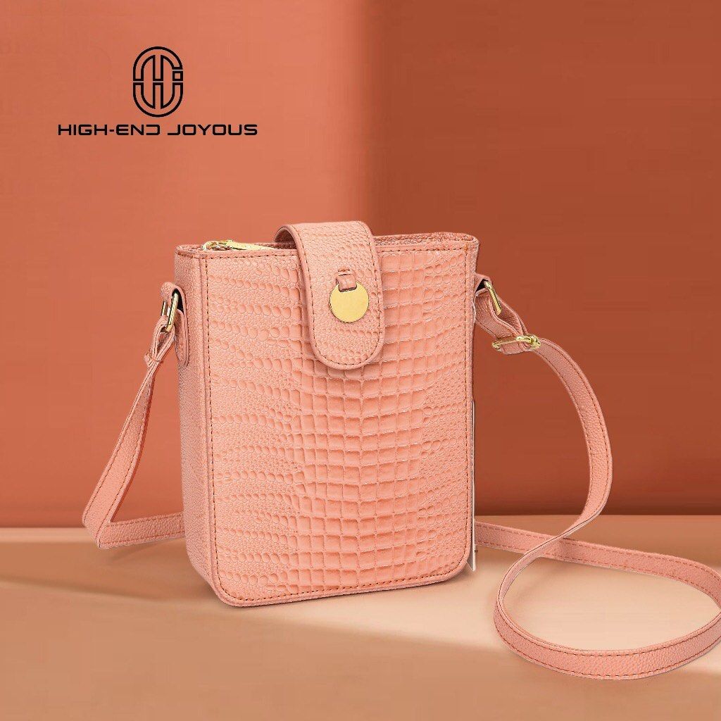 HIGH-END JOYOUS Pink Crocodile Embossed Phone Bag (Category: Cross-body Bags) located in Valenzuela. Submitted by 2ndHandSpree (Listing ID 1450318695, Image 1). Description: - Adorable pink phone bag - Chic crocodile embossed texture - Secure clasp closure - Long, adjustable strap for comfort - Elegant gold hardware details - Ideal for carrying your phone and essentials - Compact and stylish design.