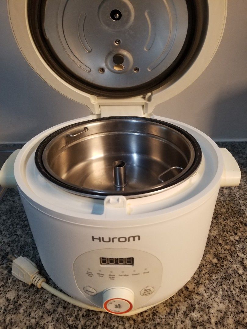 HUROM 37% Starch Reducing Rice Cooker Multi Cooker (Category: Cookers) located in Manila. Submitted by freeearth_a30d5f (Listing ID 1450148569, Image 2). Description: - HUROM 37% Starch Reducing Rice Cooker - Digital display and control panel - Durable stainless steel inner pot - Lid opens to reveal cooking chamber - Comes with a separate stainless steel bowl - Versatile for cooking rice and other dishes.