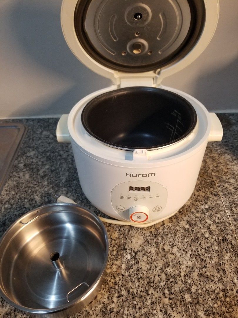 HUROM 37% Starch Reducing Rice Cooker Multi Cooker (Category: Cookers) located in Manila. Submitted by freeearth_a30d5f (Listing ID 1450148569, Image 3). Description: - HUROM 37% Starch Reducing Rice Cooker - Digital display and control panel - Durable stainless steel inner pot - Lid opens to reveal cooking chamber - Comes with a separate stainless steel bowl - Versatile for cooking rice and other dishes.