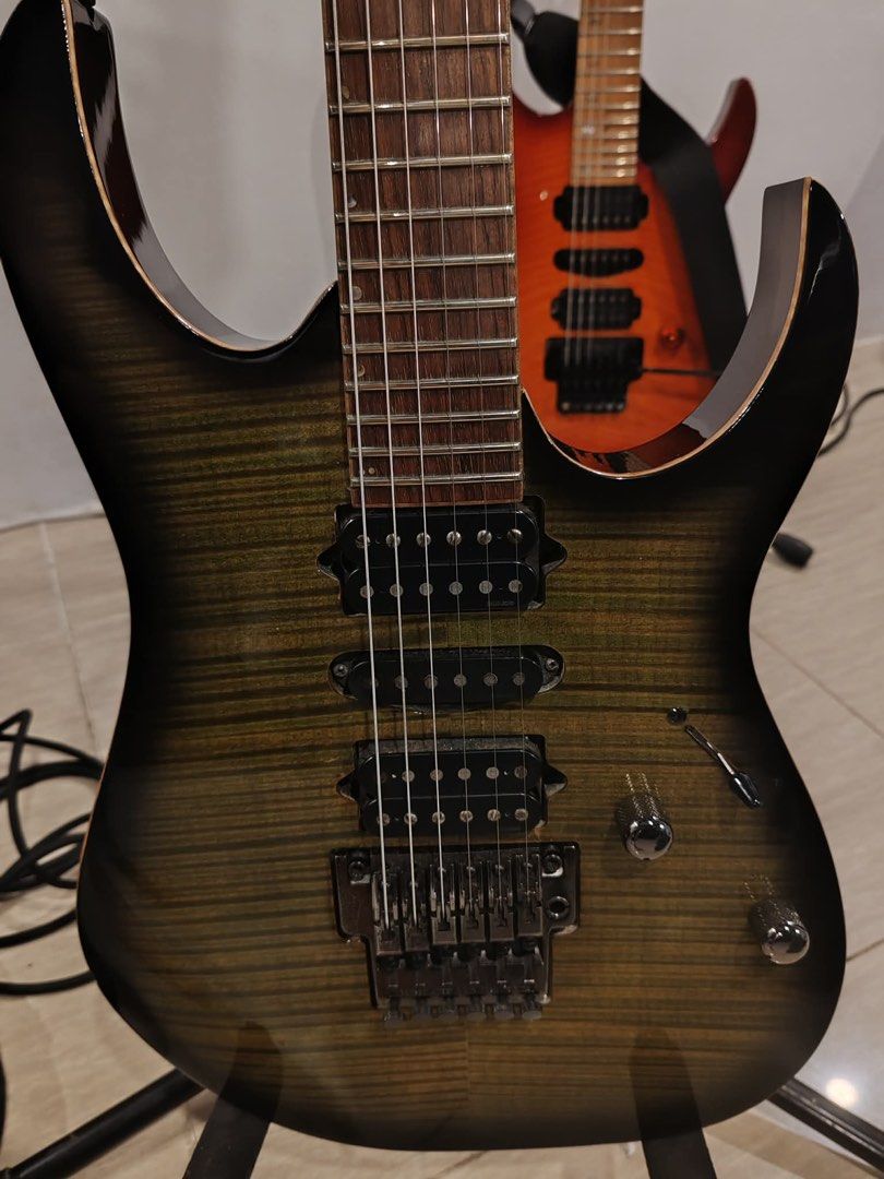 Ibanez J. Custom RG1880 (Category: Musical Instruments) located in Manila. Submitted by 12tonemusicstudioph (Listing ID 1450308411, Image 3). Description: - Ibanez J. Custom electric guitar - Stunning flame maple top with sunburst finish - Dual humbucker pickups for powerful sound - Floyd Rose tremolo system for dive bombs and vibrato - Fast, smooth neck ideal for shredding - Perfect for rock and metal music genres - Includes a cool skeleton-them